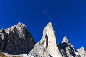Jet plane with vapour trail flies over the Three Peaks, view from the south side, Dolomites, South Tyrol, Italy, Europe