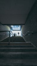 Man on the stairs of underground tunnel