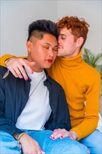 Portrait of beautiful gay couple making up and kissing, smiling indoors at home, lgbt concept