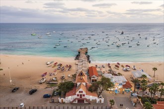 Pier and boats on turquoise water in city of Santa Maria, island of Sal, Cape Verde, Africa