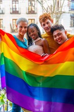 Portrait of couples of gay guys and lesbian girls in a portrait with rainbow flag, lgtb concept