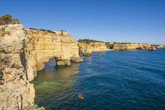 Beautiful cliffs and rock formations by the Atlantic Ocean at Marinha Beach in Algarve, Portugal, Europe