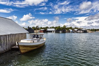 Boat and boathouses in the harbour, Kaeringsund fishing village, Fasta Aland, Aland Islands, Aland Islands, Finland, Europe