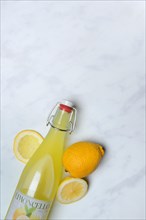 Limoncello, lemon liqueur in bottle and lemons