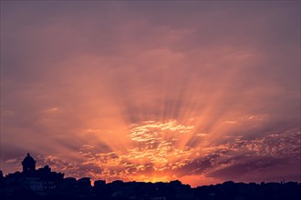 Dramatic colorful cloudy sky with picturesque clouds lit by sunset