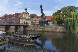 Old crane at the former port of Ilmenau, in front replica of medieval merchant ships, Lueneburg, Lower Saxony, Germany, Europe
