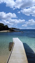 Bathing jetty from the beach into the water, opposite the island of Ishujt e Ksamilit, Ksamil, Albania, Europe