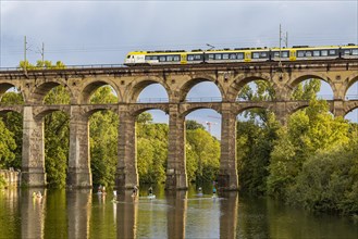 Enz viaduct Bietigheim with regional train, railway viaduct over the river Enz, stand-up paddler, Bietigheim-Bissingen, Baden-Wuerttemberg, Germany, Europe