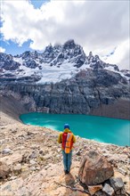 Hiker standing at the lagoon, glacial lake at Cerro Castillo mountain, Cerro Castillo National Park, Aysen, Patagonia, Chile, South America