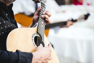 Close up of the guitar of a man playing traditional Portuguese music called fado