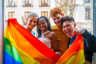 Lgtb couples of lesbian gay boys and girls in a portrait with rainbow flag