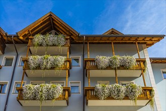 Balconies decorated with flowers in the centre of Ortisei, Val Gardena, Dolomites, South Tyrol, Italy, Europe