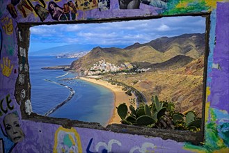 Playa de las Teresitas beach, seen through a ruin, graffiti, San Andres, back of Santa Cruz, Tenerife, Canary Islands, Spain, Europe