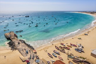 Pier and boats on turquoise water in city of Santa Maria, island of Sal, Cape Verde, Africa