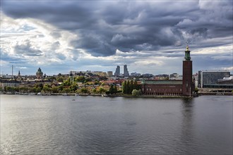 View from the viewpoint Monteliusvaegen to the island Kungsholmen with city hall Stockholms stadshus, dramatic cloudy sky, Stockholm, Maelaren, Sweden, Europe