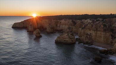 Sunset at Praia da Marinha, rocks and cliffs, steep coast in the Algarve, Portugal, Europe