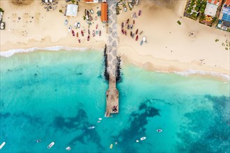 Pier and boats on turquoise water in city of Santa Maria, island of Sal, Cape Verde, Africa