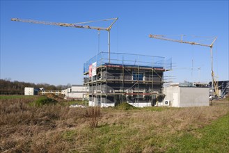 Residential building with scaffolding and flat roof, construction site in a new housing estate, Kamen, North Rhine-Westphalia, Germany, Europe