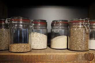 Jars with cereal grains and flakes in a bakery in Bad Urach on 25.08.2022, Bad Urach, Baden-Wuerttemberg, Germany, Europe