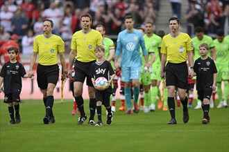 Referee Referee Dr Felix Brych and teams of VfB Stuttgart in special jerseys, symbolising diversity, LGBT, rainbow, and VfL Wolfsburg enter the pitch with run-in children, logo, SKY, Mercedes-Benz Are...