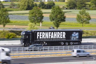 Truck with advertisement for the trade magazine Fernfahrer, on the road on the motorway, Stuttgart, Baden-Wuerttemberg, Germany, Europe