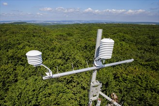A hygrometer for recording air temperature and relative humidity hangs from a measuring tower of the Northwest German Forest Research Institute above a deciduous forest in Lower Saxony. Here, research...