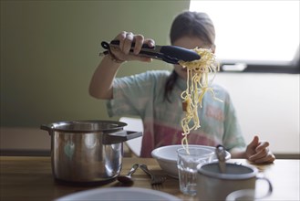 Ten year old girl with spaghetti, Bonn, Germany, Europe