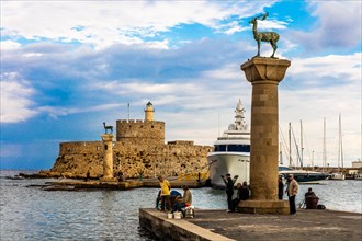 Mandraki harbour, harbour entrance with columns with stag and hind, site of the Colossus of Rhodes, Rhodes Town, Greece, Europe