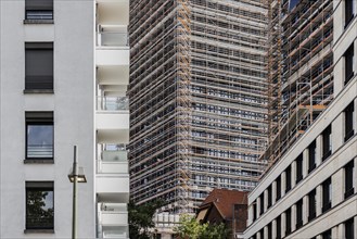 A scaffolded new building looms between two completed buildings in Berlin, 26.06.2022., Berlin, Germany, Europe