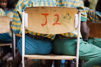 Theme: Schoolchildren in Africa. Two children share a seat., Krokrobite, Ghana, Africa