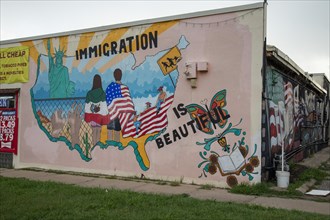 Wichita, Kansas, A pro-immigration mural on the wall of a store in Wichitas predominantly Latino NorthEnd neighborhood. It is part of the Horizontes Project, which aims to bring together the NorthEnd ...