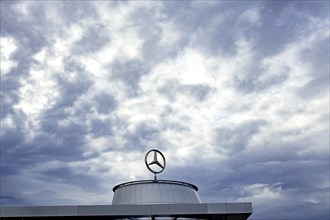 Mercedes star above the Mercedes Center in Untertuerkheim, clouds in the sky, Stuttgart, Baden-Wuerttemberg, Germany, Europe