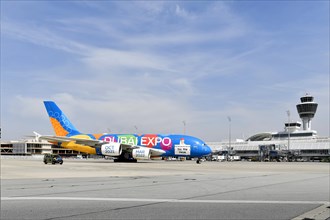 Rolling Emirates Airlines special livery Expo Dubai 2021-2022 Airbus A380-800 in front of Terminal 1 with Tower, Munich Airport, Upper Bavaria, Bavaria, Germany, Europe