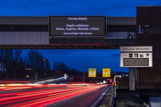 Vario display on the B10 B14 trunk road with information on corona protection, night photograph with light traces of vehicles, Stuttgart, Baden-Wuerttemberg, Germany, Europe