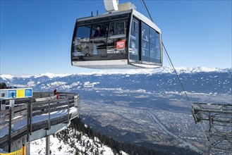 Seegruben cable car hovers over access to the Dreierstuetze chairlift, Nordkette ski area Innsbruck, Tyrol