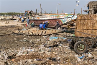 Plastic waste and broken fishing boats in Missirah, Sine Saloum Delta, Senegal, West Africa, Africa