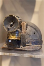 Beckley, West Virginia, A miners carbide lamp attached to his helmet on display at the mine museum at the Beckley Exhibition Coal Mine. In the lamp, calcium carbide reacts with water to produce acetyl...