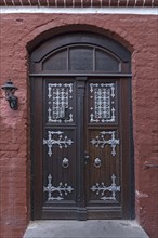 Old front door with silver-coloured fittings in the old town, Lueneburg, Lower Saxony, Germany, Europe