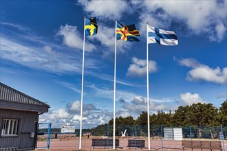 Three flags side by side, Sweden, Aland, Finland, sunny weather, Eckeroe ferry terminal, Fasta Aland, Aland Islands, Aland Islands, Finland, Europe