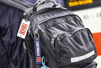 Locomotive driver with backpack and distinctive sign of the locomotive drivers of the Deutsche Bahn, main station, Stuttgart, Baden-Wuerttemberg, Germany, Europe