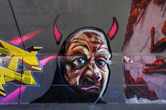 Devils grimace, graffiti in the driveway to Kempten main station, Allgaeu, Bavaria, Germany, Europe