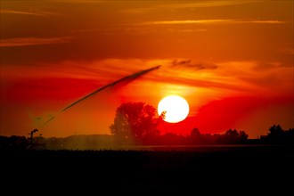 Irrigation of the fields with a circular sprinkler, sunset, light mood, backlight, drought, hot spell, water shortage, drought, Roeckrath, North Rhine-Westphalia, Germany, Europe