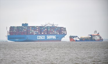 Container ship Cosco Shipping encounters ship Van Oord in fog on the Elbe near Hamburg, Schleswig-Holstein, Germany, Europe
