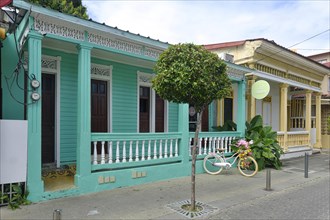 Colonial houses with bicycle in Centro Historico, Old Town of Puerto Plata, Dominican Republic, Caribbean, Central America