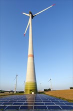 Photovoltaic system on the open spaces in front of wind turbines at the Lichtenau wind farm, Paderborner Land, East Westphalia, rural, fields, agriculture, evening, sunset