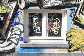 Window with colourful graffiti mural on a house wall, Bremen, Germany, Europe