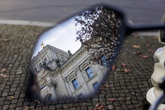 Part of the building of the German Bundestag can be seen in a motorbike mirror. Berlin, Berlin, Germany, Europe