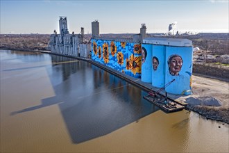Toledo, Ohio, The Glass City River Wall, a sunflower mural by Gabe Gault, painted on the ADM grain silos on the Maumee River