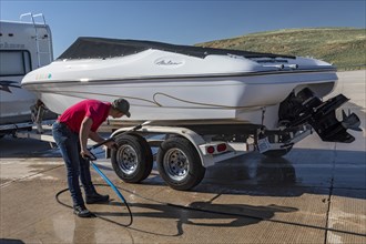 Evanston, Wyoming, An employee of the Wyoming Game & Fish Department inspects and decontaminates watercraft at a mandatory inspection station along the Utah border. The intent is to keep invasive aqua...