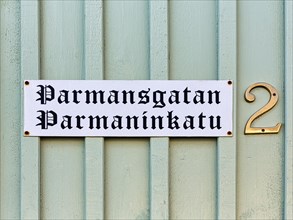 Bilingual street sign on wooden facade, wooden house, street name Parmansgatan in Swedish and Finnish, house number 2, Old Town of Kristinestad, Kristiinankaupunki, Oesterbotten, Finland, Europe
